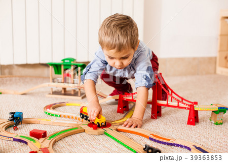 Boy plays with train Boy plays with train 39363853