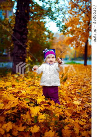 Young girl standing in foliage 39365257