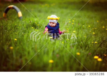 Young girl with wreath on lawn Young girl with wreath on lawn 39365286