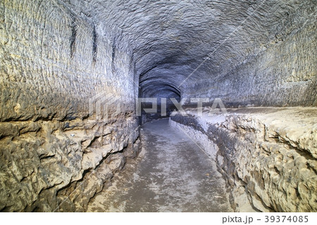 The mined cave. Sandstone tunnel moistened walls. The mined cave. Sandstone tunnel moistened walls. 39374085