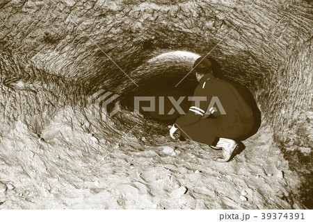 Miner underground in mine tunnel.  Worker do job 39374391