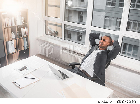 Glad respectable man resting in cabinet and Glad respectable man resting in cabinet and 39375568