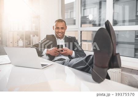 Happy handsome businessman resting at cabinet with Happy handsome businessman resting at cabinet with 39375570