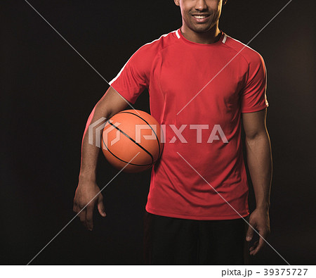 Man in red t-shirt with orange ball 39375727