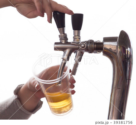 Barman pours beer into a plastic glass Barman pours beer into a plastic glass 39381756