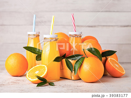 Glass bottles of raw organic fresh orange juice Glass bottles of raw organic fresh orange juice 39383177