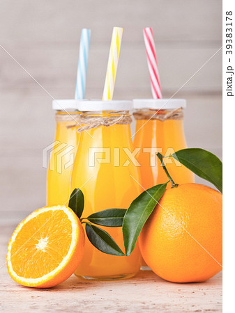 Glass bottles of raw organic fresh orange juice Glass bottles of raw organic fresh orange juice 39383178