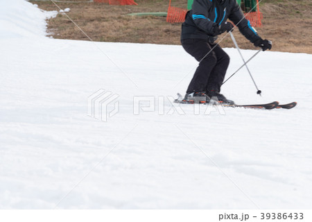 Skiers and snowboarders riding on a ski slope 39386433
