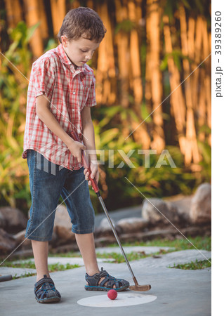 Happy little boy  playing mini golf. 39389260