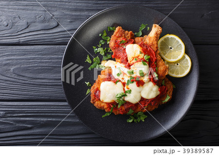 Veal Milanesa Napolitana with mozzarella cheese 39389587