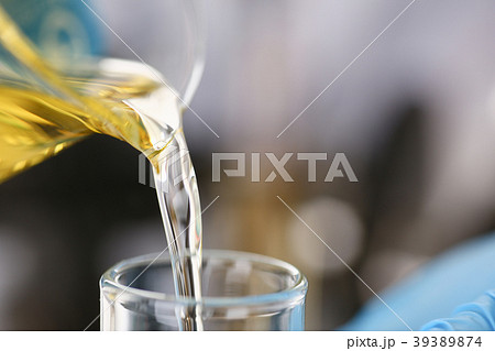 Male hands in protective gloves hold test tube Male hands in protective gloves hold test tube 39389874