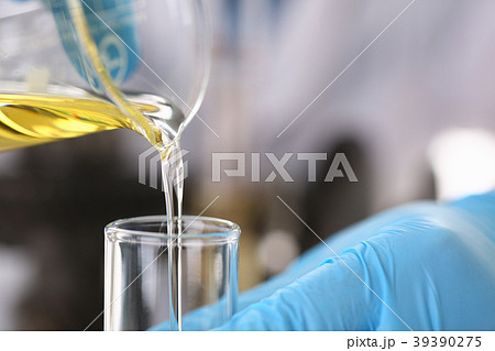 Male hands in protective gloves hold test tube Male hands in protective gloves hold test tube 39390275