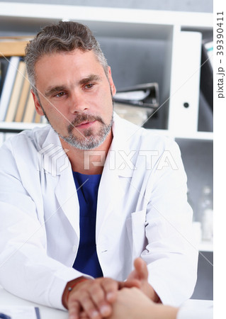 Friendly male doctor hold female arm Friendly male doctor hold female arm 39390411