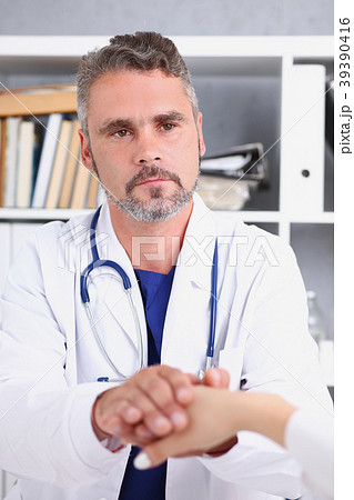 Friendly male doctor hold female arm Friendly male doctor hold female arm 39390416