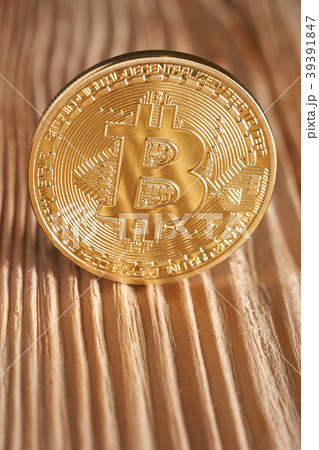 Golden bitcoin on wooden background. Golden bitcoin on wooden background. 39391847