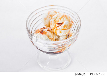 Vanilla ice cream with caramel syrup on white Vanilla ice cream with caramel syrup on white 39392425