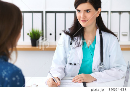 Beautiful female doctor and patient having a talk 39394433