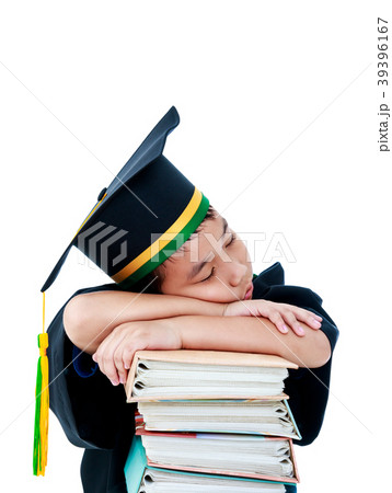 Child in graduation gown with many books. Isolated 39396167