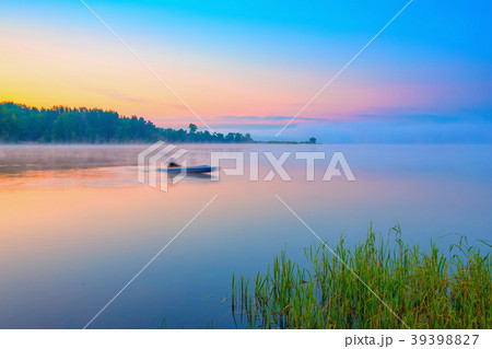 Canoe on a forest lake at sunrise 39398827