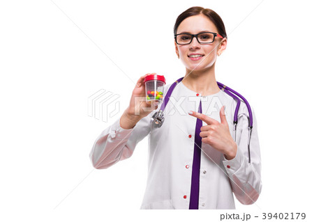 Young beautiful female doctor holding bottle of 39402179