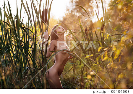 Sexual nude woman posing in the thicket of reeds. 39404603