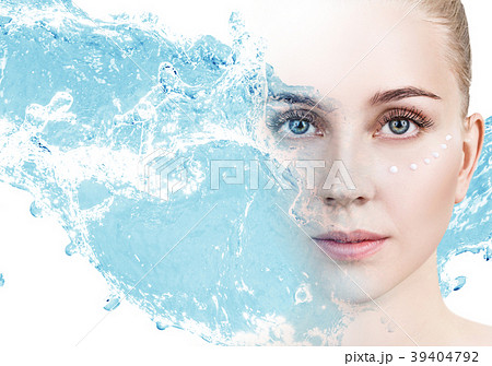 Woman with cream dots on face in blue water splash Woman with cream dots on face in blue water splash 39404792