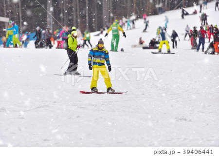 Young man on snowboard downhill Young man on snowboard downhill 39406441