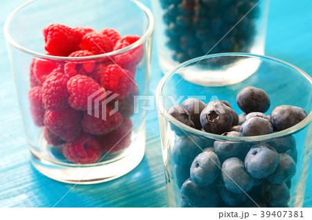 row of wild berries in bowls on wooden background row of wild berries in bowls on wooden background 39407381