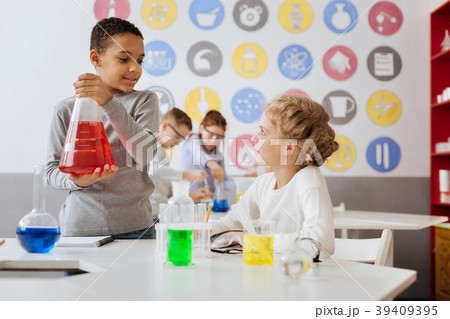 Pleasant boy talking with his team partner during Pleasant boy talking with his team partner during 39409395