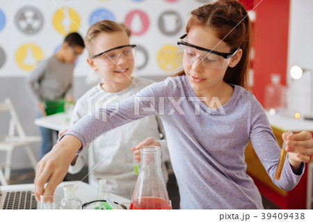 Cheerful students being busy with chemical 39409438