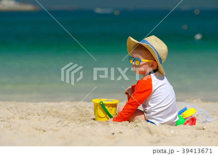 Two year old toddler playing on beach Two year old toddler playing on beach 39413671