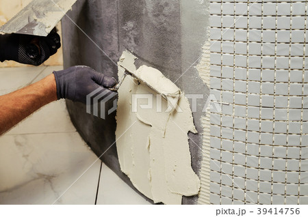 Installation of mosaic tiles. 39414756