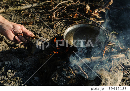 Kettle on charcoal fire. Kettle on charcoal fire. 39415183