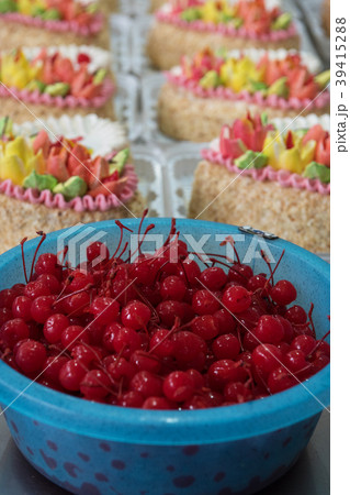Bowl of cherry on cake production 39415288