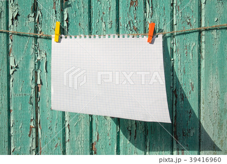 White checkered sheet of paper on the wooden wall White checkered sheet of paper on the wooden wall 39416960