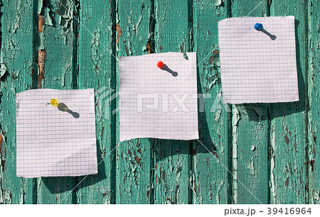 Three white sheets of paper on the wooden wall Three white sheets of paper on the wooden wall 39416964