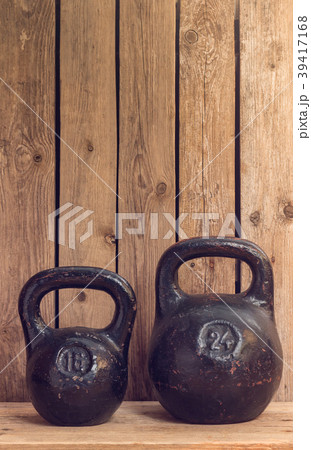 Pair of two old heavy iron kettlebells 39417168