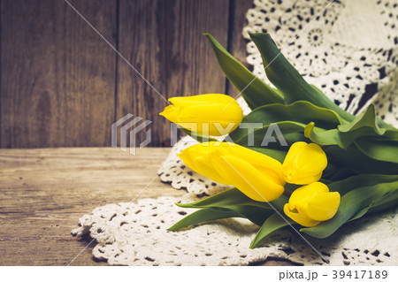Bouquet of tulips on lace with wooden background Bouquet of tulips on lace with wooden background 39417189