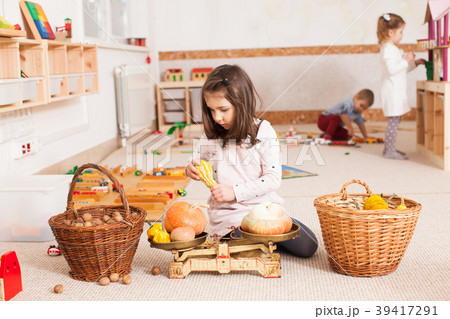 cute little girl is playing with scales cute little girl is playing with scales 39417291
