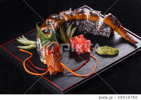 Sushi dragon with eel, cucumber and avocado on a Sushi dragon with eel, cucumber and avocado on a 39419760