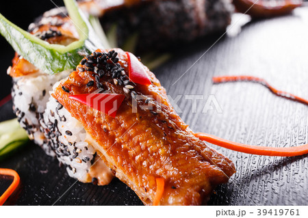 Sushi dragon with eel, cucumber and avocado on a Sushi dragon with eel, cucumber and avocado on a 39419761