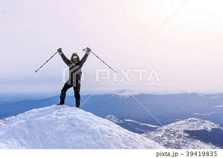 climber rejoices, reaching the top of the mountain 39419835