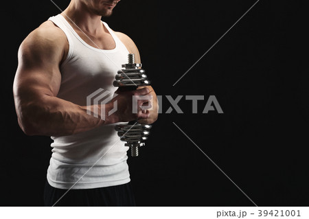 Strong athletic man with dumbbell showes muscular 39421001