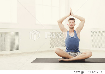 Man training yoga in lotus pose, copy space Man training yoga in lotus pose, copy space 39421294