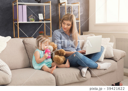 Young mother working and spending time with baby 39421622