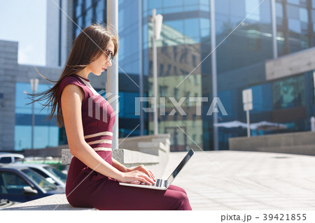Businesswoman working with laptop outdoors 39421855