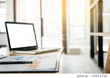 Sideview of office desktop with blank laptop and various office 39423192