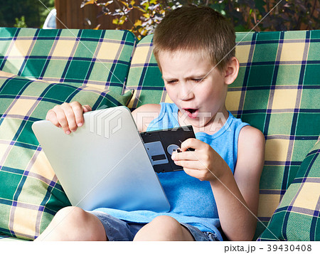 Little boy with floppy disk and tablet pc 39430408