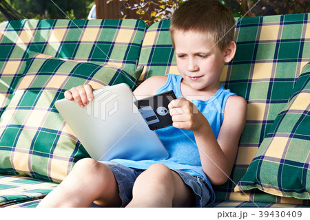 Little boy with floppy disk and tablet pc 39430409