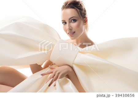 Nude girl sitting with huge decorative bow Nude girl sitting with huge decorative bow 39430656
